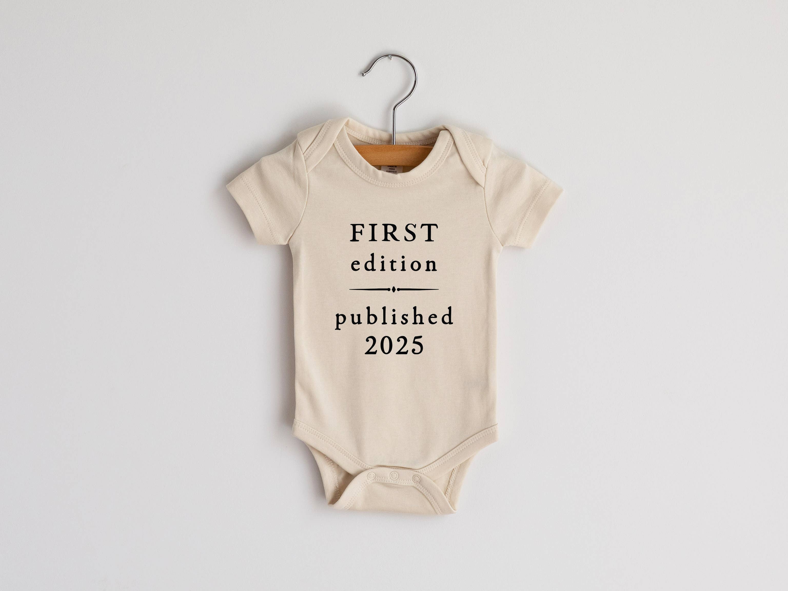Cream First Edition 2025 Book Style Organic Onesie